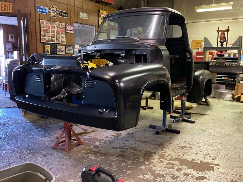 Wicked 53 — 1953 Ford build in progress with cab and front clip in black, mocked up on shop stands during chassis fitment.