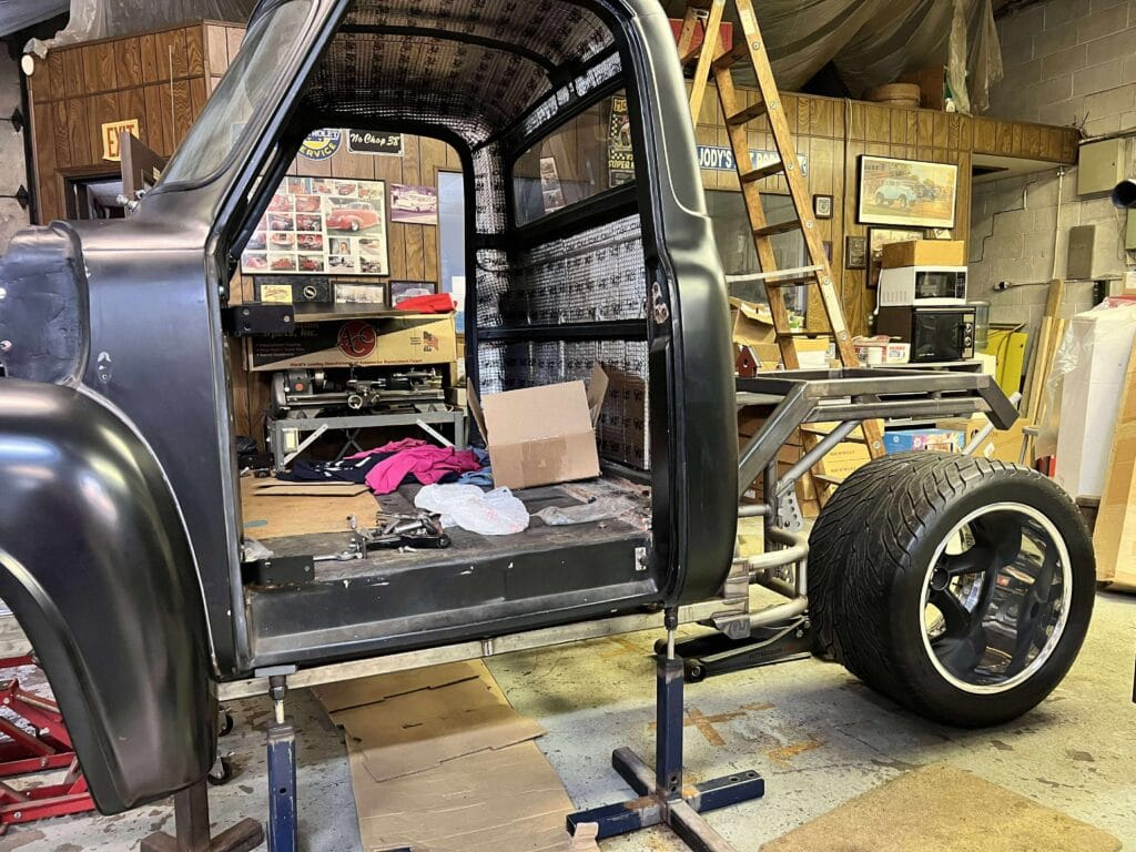1953 Ford “Wicked 53” cab mocked up on stands with oversized rear tire