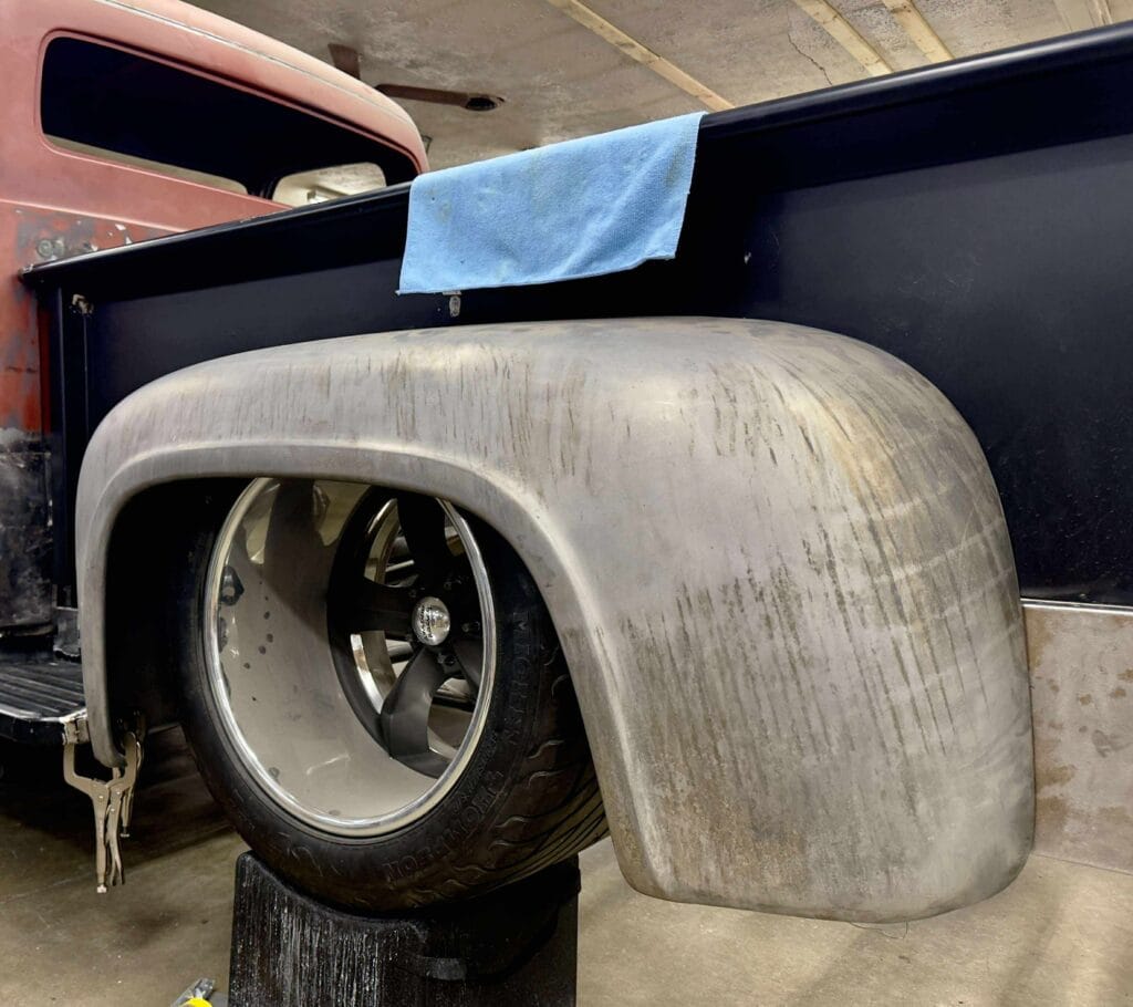 Hand-worked rear fender and tub in bare metal