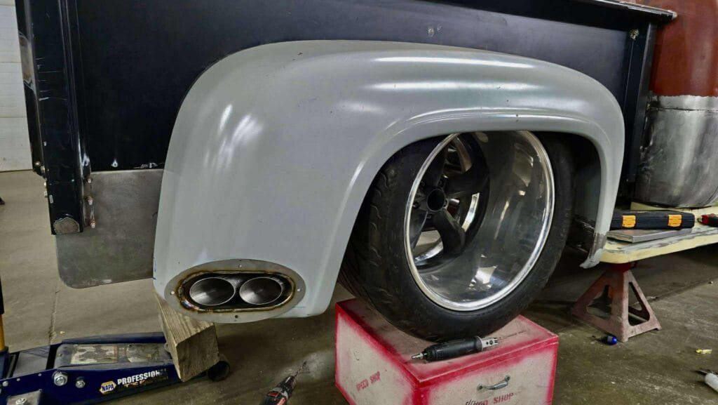 Dual oval exhaust exits integrated into rear fender