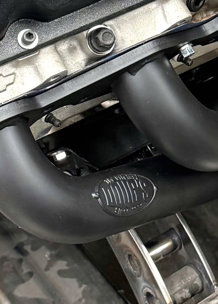 Wicked 53 — Doug’s Headers long-tube, black ceramic, at ZZ502 cylinder head; logo and flange detail visible.