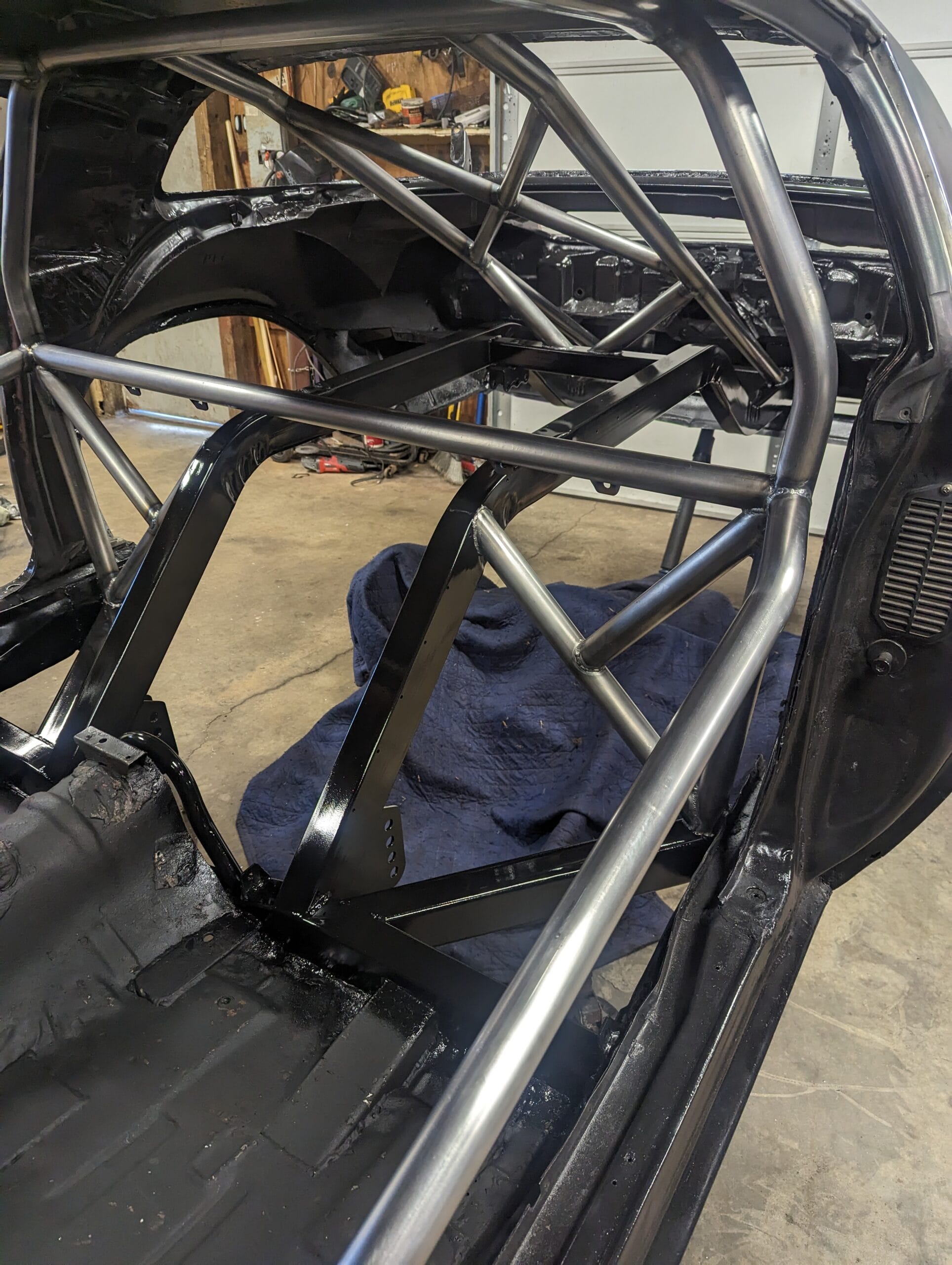 Fabricated roll cage and back-half chassis work on Rusty Kedik’s 1980 Camaro Z28 “Pandemic,” showing custom tubing, bracing, and rear frame structure.