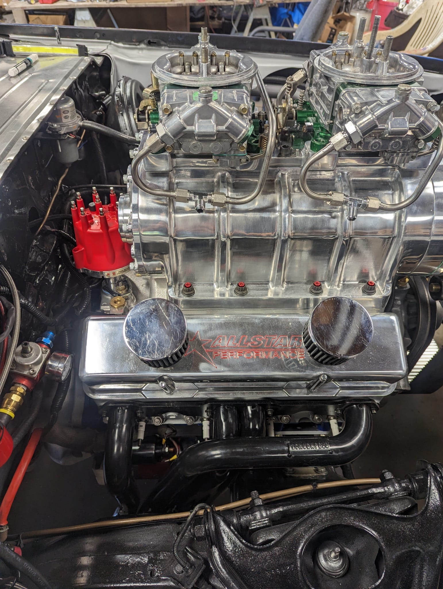 Polished big-block Chevy with dual carburetors on a roots blower inside the Pandemic Camaro engine bay.