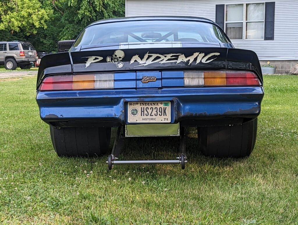 Rear view of the Pandemic 1980 Camaro Z28 showing the big slicks, wheelie bar, custom back-half stance, and rear spoiler decal.