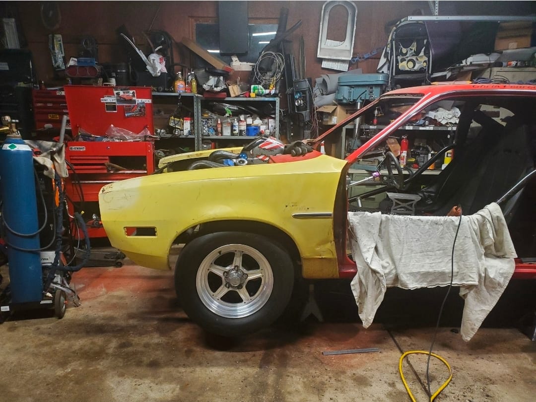 Early garage build of the 1974 Ford Pinto “Chinto” showing custom fabrication and home-built race car progress