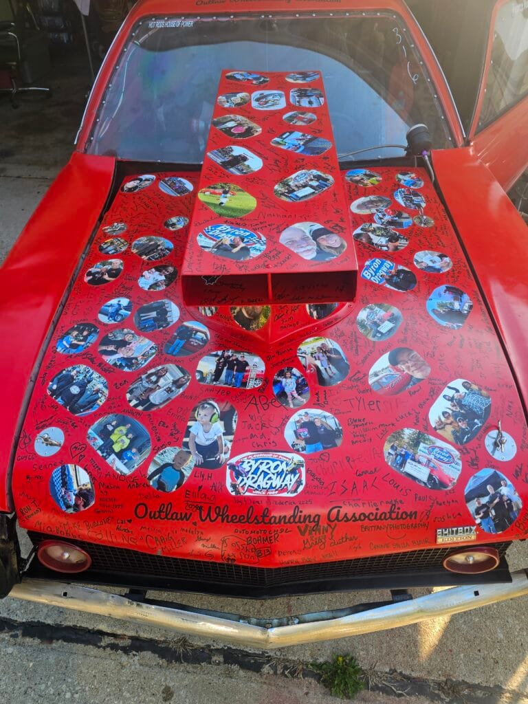Signed hood from the 1974 Ford Pinto “Chinto” covered with fan signatures and photos from Outlaw Wheelstanding Association events