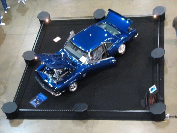 1968 Camaro Sapphire displayed indoors at a car show with hood and trunk open